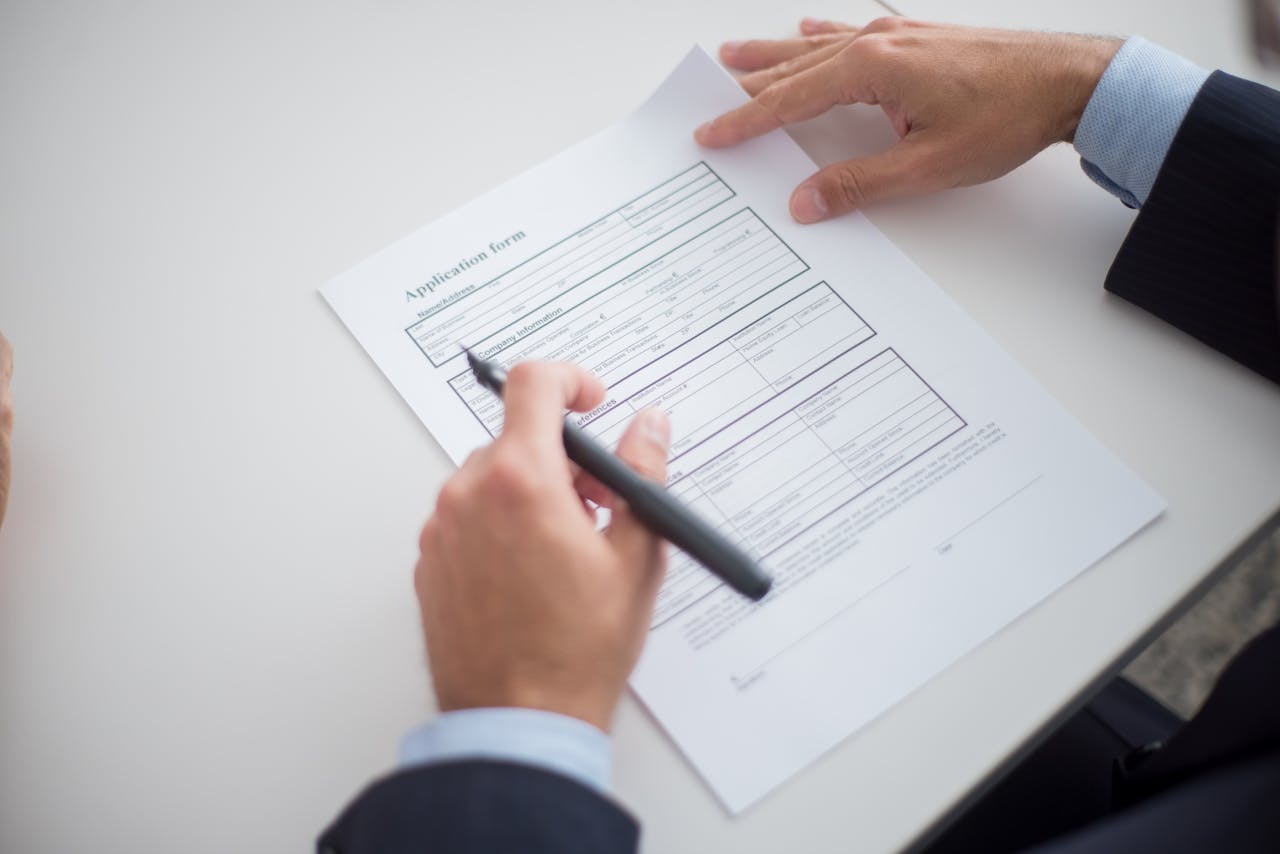 Home Close-up of a business professional reviewing an application form at a desk.